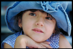 Casual Head and Shoulders Portrait of a young girl wearing a hat